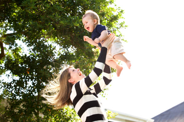 istock happy mother playing with baby outside 901828344