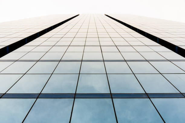 istock Bottom view of office building window close up with sunrise, reflection and perspective. 901834160