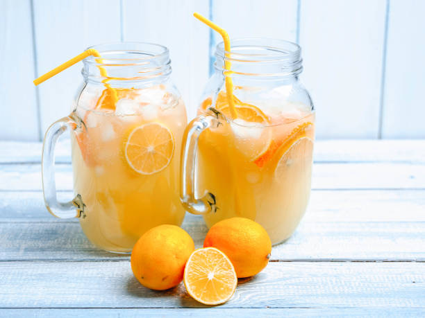 istock Orange lemonade on a wooden background. Soft drinks 901837158