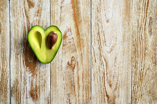 istock Heart shaped avocado on wooden background 901838242