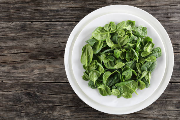 istock Baby spinach leaves on a white plates 901838346