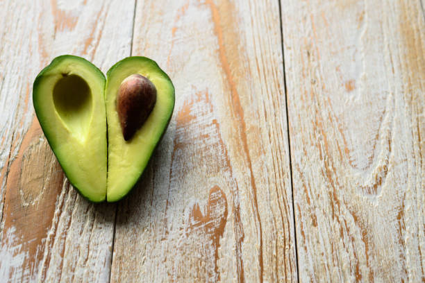 istock Heart shaped avocado on wooden background 901838822