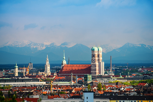 Iconic Frauenkirche of Munich, Bavaria, Germany with alps in the background