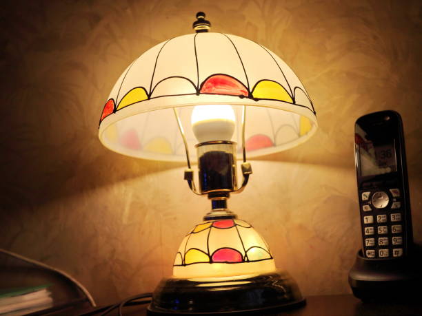 istock table lamp with a glow and a phone on the table 901844664