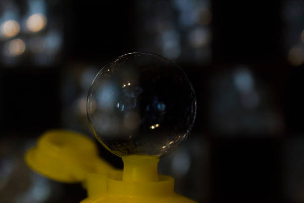 Soap bubble from neck of bottle, soft focus. Soft background with soap bubble