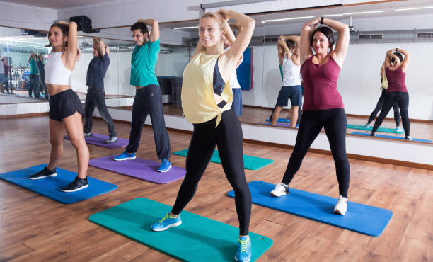 istock Happy people studying zumba elements in dancing hall 901850308