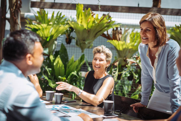 istock Smiling manager and CEO talking to her subordinated during relaxed meeting 901853942