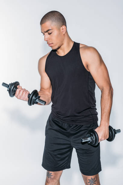 istock sportsman training with dumbbells isolated on white 901854804