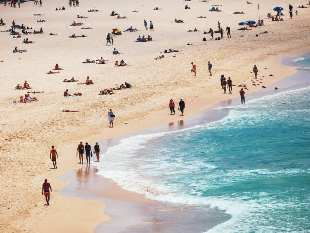 istock Crowded beach with people and shallow water 901855040