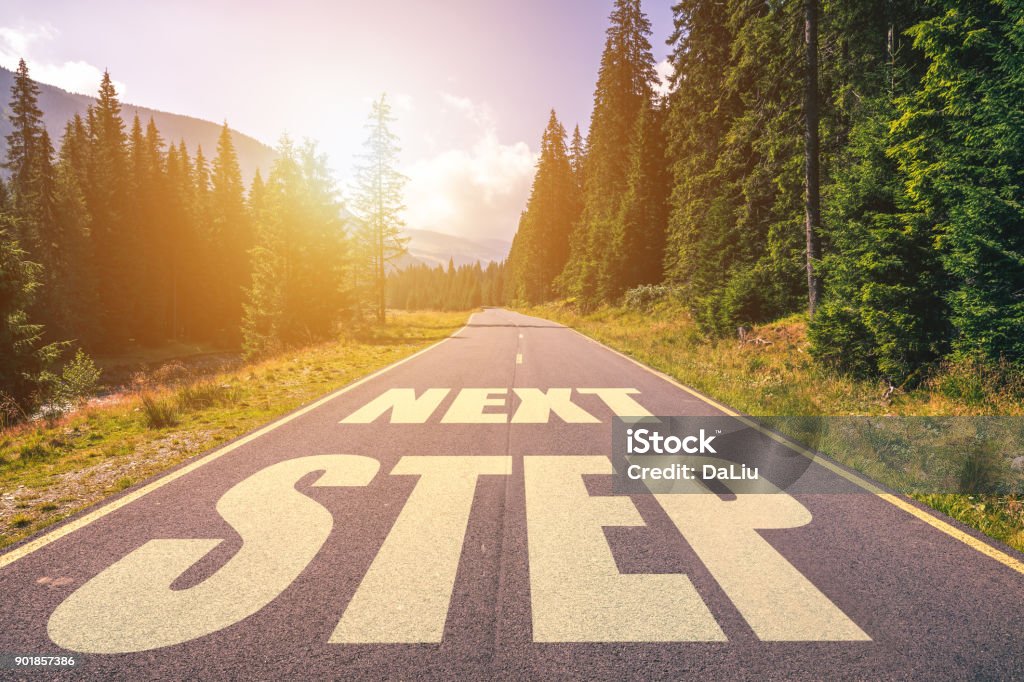 Road concept, Next Step written on the road in the mountains The Next Step Stock Photo