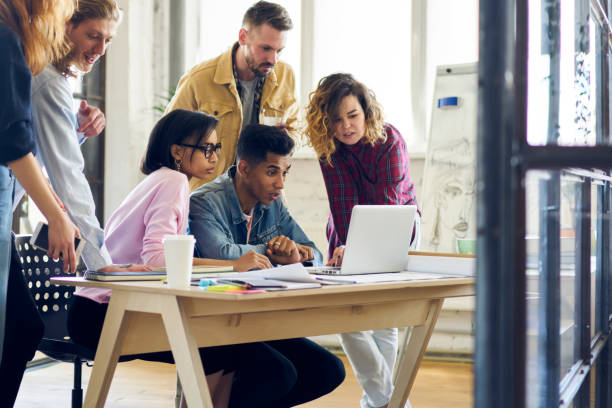 istock Young group of international students watching together training webinar learning new information and improving skills, marketing experts collaborating on promotional video for advertising campaign 901863376