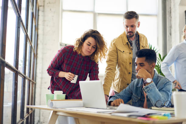 istock International group of skilled marketing experts watching training webinar on laptop connected to wireless internet for improving personal skills and knowledge during brainstorming session indoors 901863494