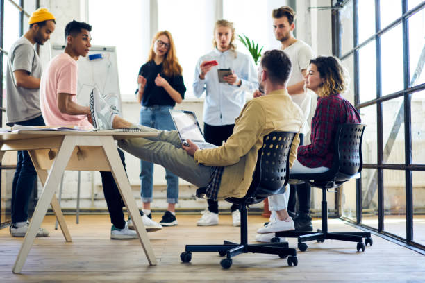istock International group of professional marketing experts planning working process and developing advertising campaign while using modern technology and internet connection in loft interior office 901863542