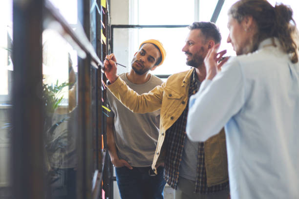 istock Professional male project manager making consultancy meeting with staff members presenting creative solution of problems with law income while collaboration on advertising campaign for company 901866908