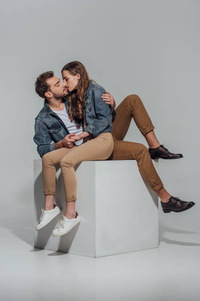 istock couple hugging and kissing on grey 901870120