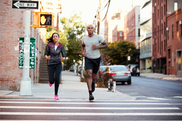 istock Young black couple jogging in Brooklyn street 901870258