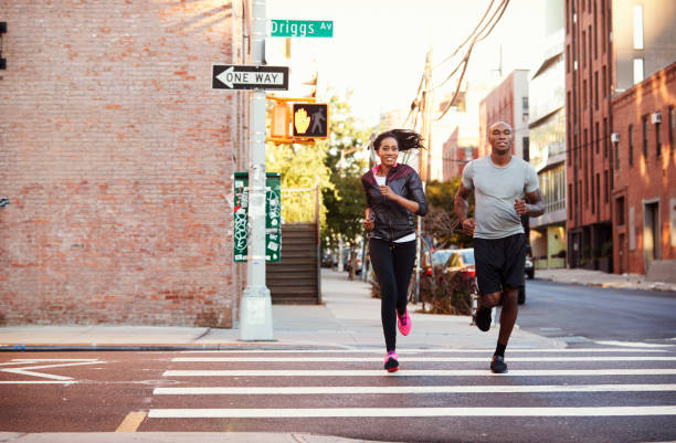 istock Young black couple jogging in Brooklyn street 901870436