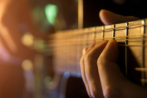 istock Man is playing the guitar, close up 901871334