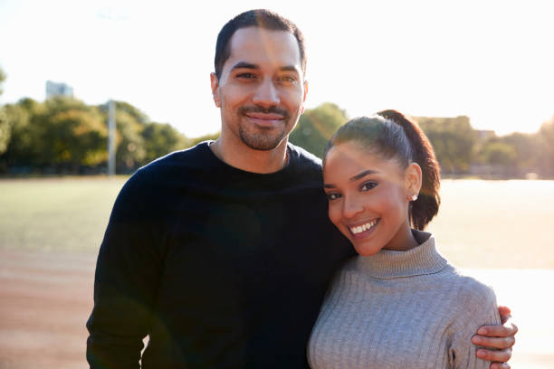 istock Young couple smiling at camera in Brooklyn, close up 901872200