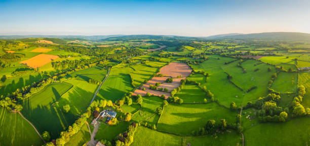 aerial panorama over green patchwork fields idyllic rural countryside landscape - river usk imagens e fotografias de stock