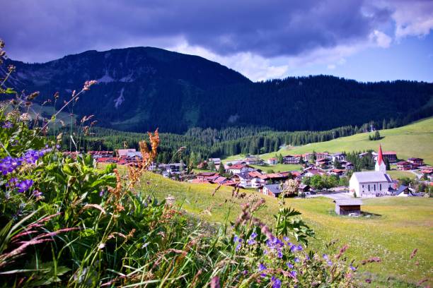 istock Church in golden light under a dark blue brooding sky in Berwang, Tirol 901875394