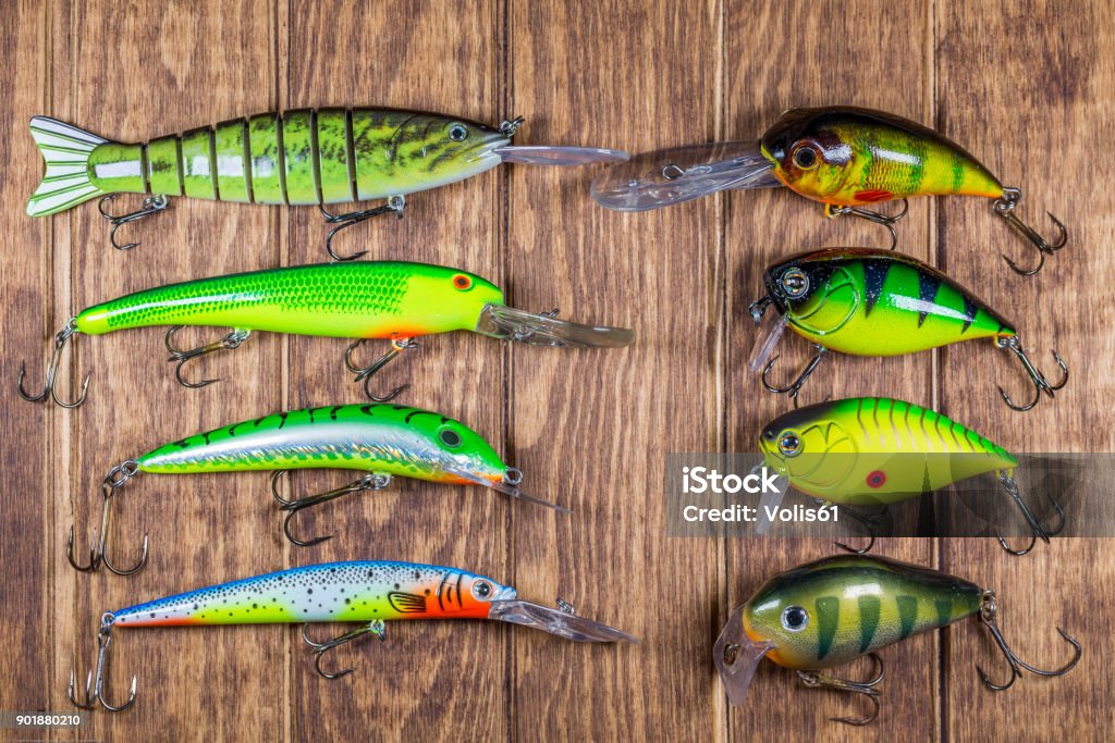Fishing Lures Side By Side On Wooden Background Stock Photo