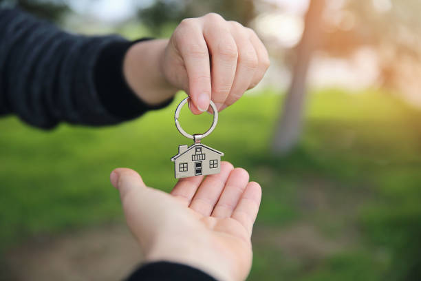 istock Woman receiving house key 901886968