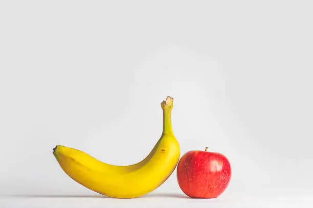 Photo of Close-Up Of Apple And Banana Against White Background