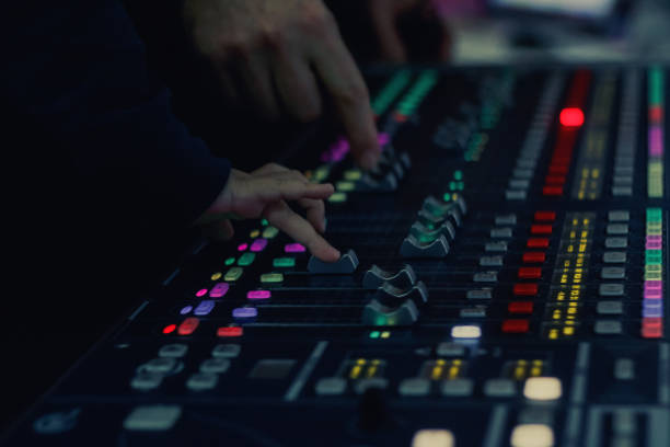 istock Close up of DJ adjusting volume on audio mixer. 901888324