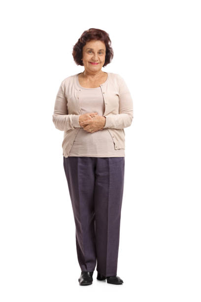 Elderly woman looking at the camera and smiling Full length portrait of an elderly woman looking at the camera and smiling isolated on white background full body isolated stock pictures, royalty-free photos & images