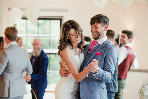 Newly Wed Couple Dancing With Their Guests Newly wed couple are dancing together on their wedding day with all of their guests. guest photos stock pictures, royalty-free photos & images