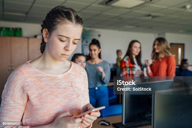 Teenage Girl Being Bullied By Text Message Stock Photo - Download Image Now - Bullying, Cyberbullying, Teenager