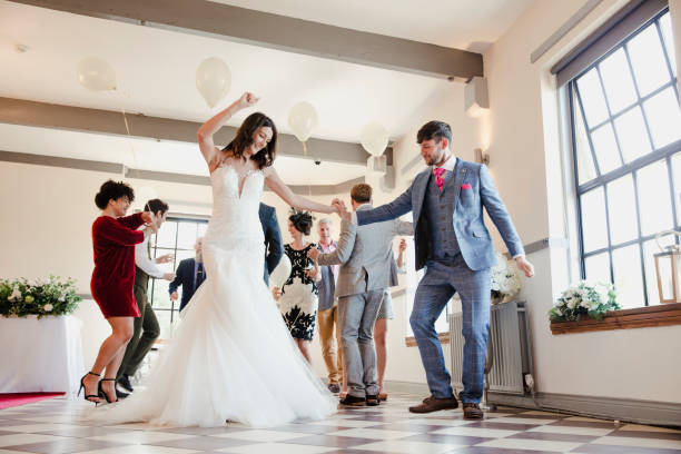 Dancing On Our Wedding Day Newly wed couple are enjoying dancing with all of their guests on their wedding day. free wedding stock pictures, royalty-free photos & images
