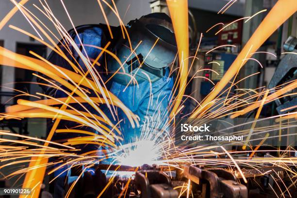 Worker Is Welding In Car Factory Stock Photo - Download Image Now - Welder, Welding, Sparks