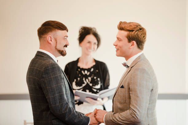 Two Men Exchanging Vows On Their Wedding Day Two men are exchanging vows on their wedding day. civil partnership stock pictures, royalty-free photos & images