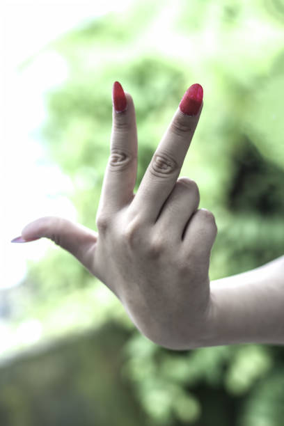 istock A hand wearing fake artificial nails showing them in various positions. 901903514