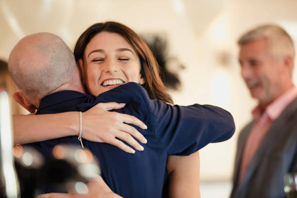 Sharing A Moment With Dad On My Wedding Day Beautiful bride is sharing a dance with her proud father. They are laughing while hugging with their arms around each other. bride hugging father on wedding day stock pictures, royalty-free photos & images