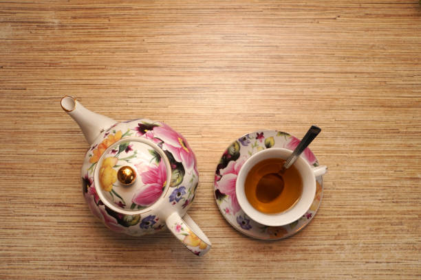 istock Tea in a cup on the table and a tea pot 901908222