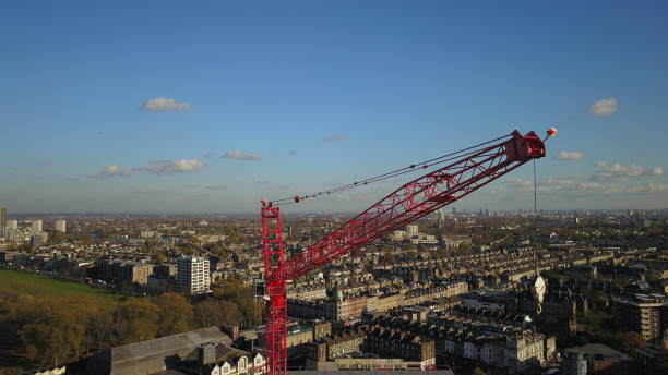 istock Aerial Drone image of a construction worker standing on a very tall tower crane with the London (england) skyline in the background. 901913288