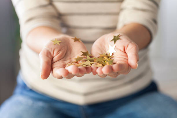 istock Girl holding gold stars 901913380