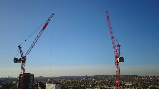 istock Aerial Drone image of a construction worker standing on a very tall tower crane with the London (england) skyline in the background. 901915850