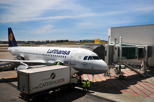 Lisbon, Portugal: Lufthansa Airbus A320-200 (D-AIQL Stralsund) airliner receiving catering from a Cateringpor truck at Lisbon Airport (Humberto Delgado airport), jet bridge at terminal 1 - Deutsche Lufthansa AG, aka Lufthansa German Airlines