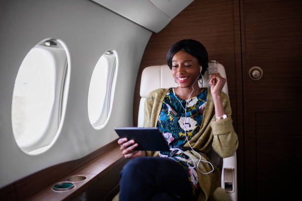 istock Woman in private jet airplane 901921368