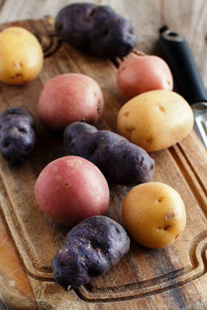 istock Raw potatoes with a vegetable peeler 901924648