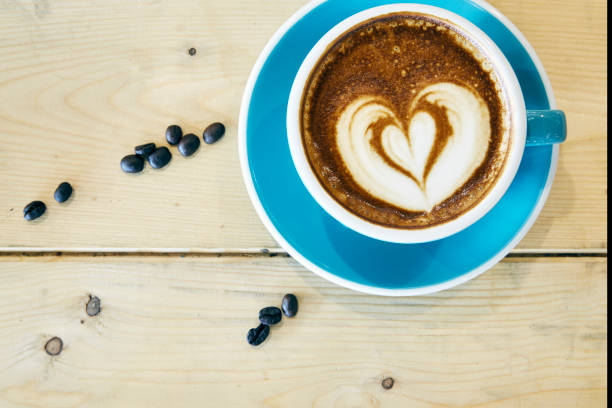 istock Hot coffee drawing heart in blue cup 901926322