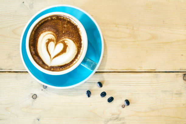 istock Hot coffee drawing heart in blue cup 901926364