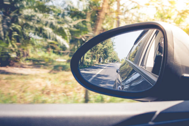istock Reflection roadway view on side mirror car during driving car on the way. (Selective focus) 901926848