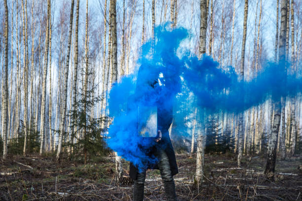 istock Young man posing with a smoke bomb. 901932238