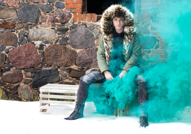 istock Young man posing with a smoke bomb. 901932276