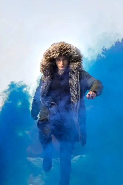 Photo of Young man posing with a smoke bomb.